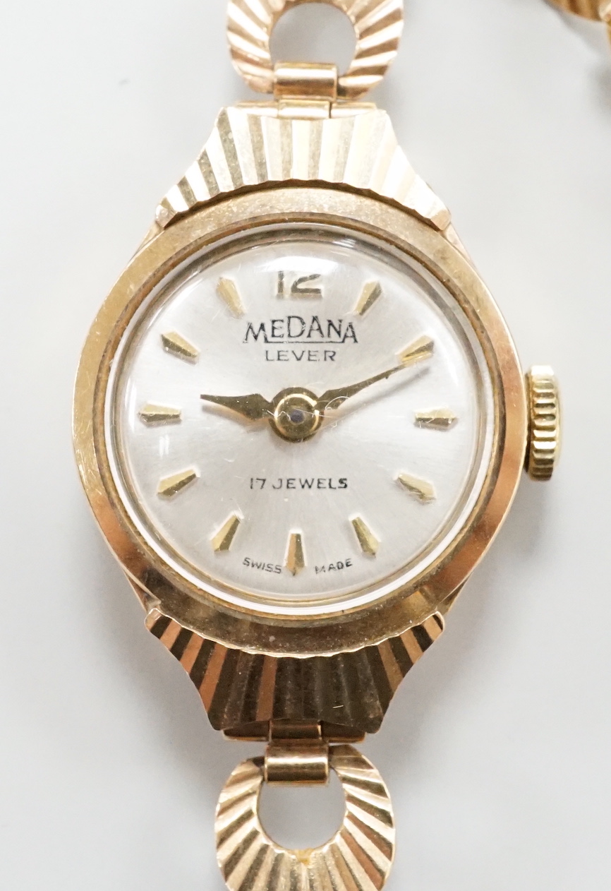 A lady's 9ct gold Medana manual wind wrist watch, on a 9ct gold bracelet